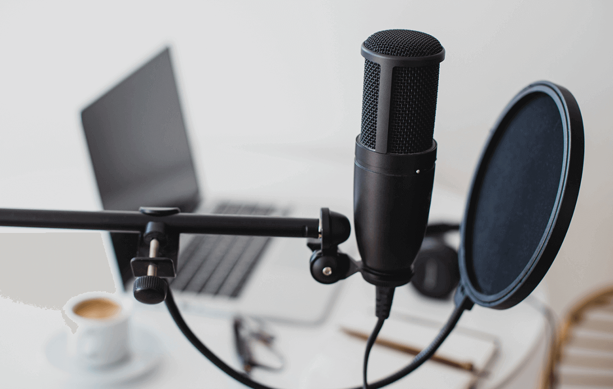 Podcast microphone and laptop setup.